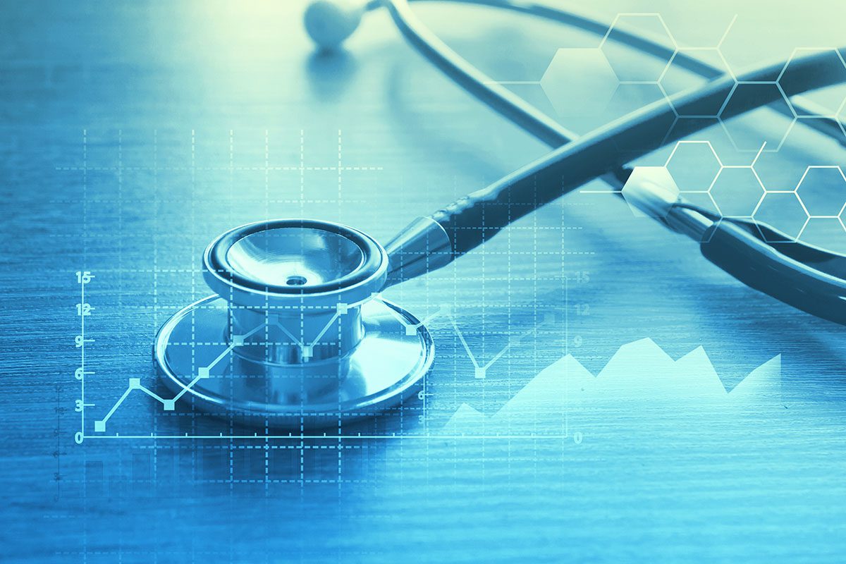 A stethoscope rests on a table with overlay graphics of medical data charts and hexagonal patterns, symbolizing healthcare and medical technology.
