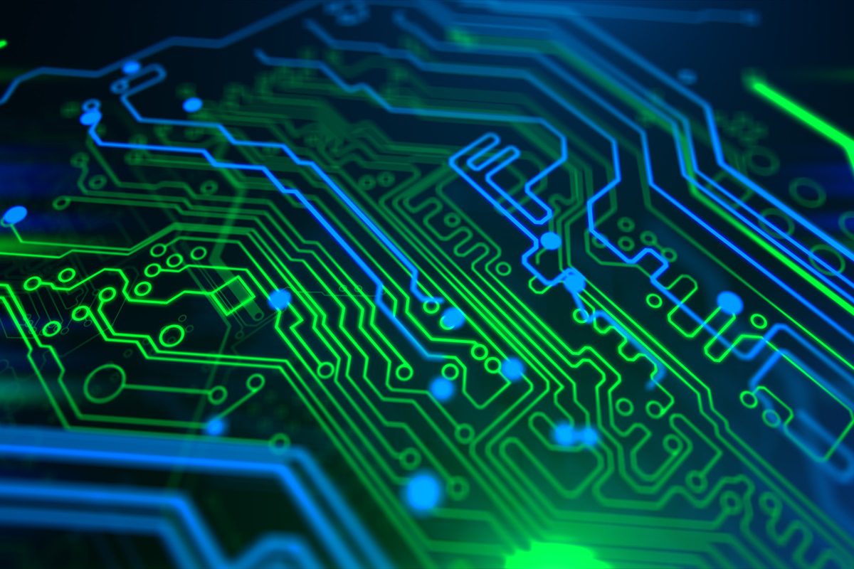 Close-up view of a blue and green illuminated computer circuit board with intricate electronic pathways and components.