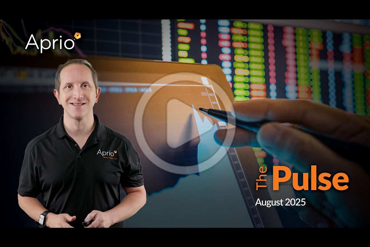 A man in an Aprio shirt stands in front of a screen displaying financial charts, with the text The Pulse August 2025 and a play button in the center.