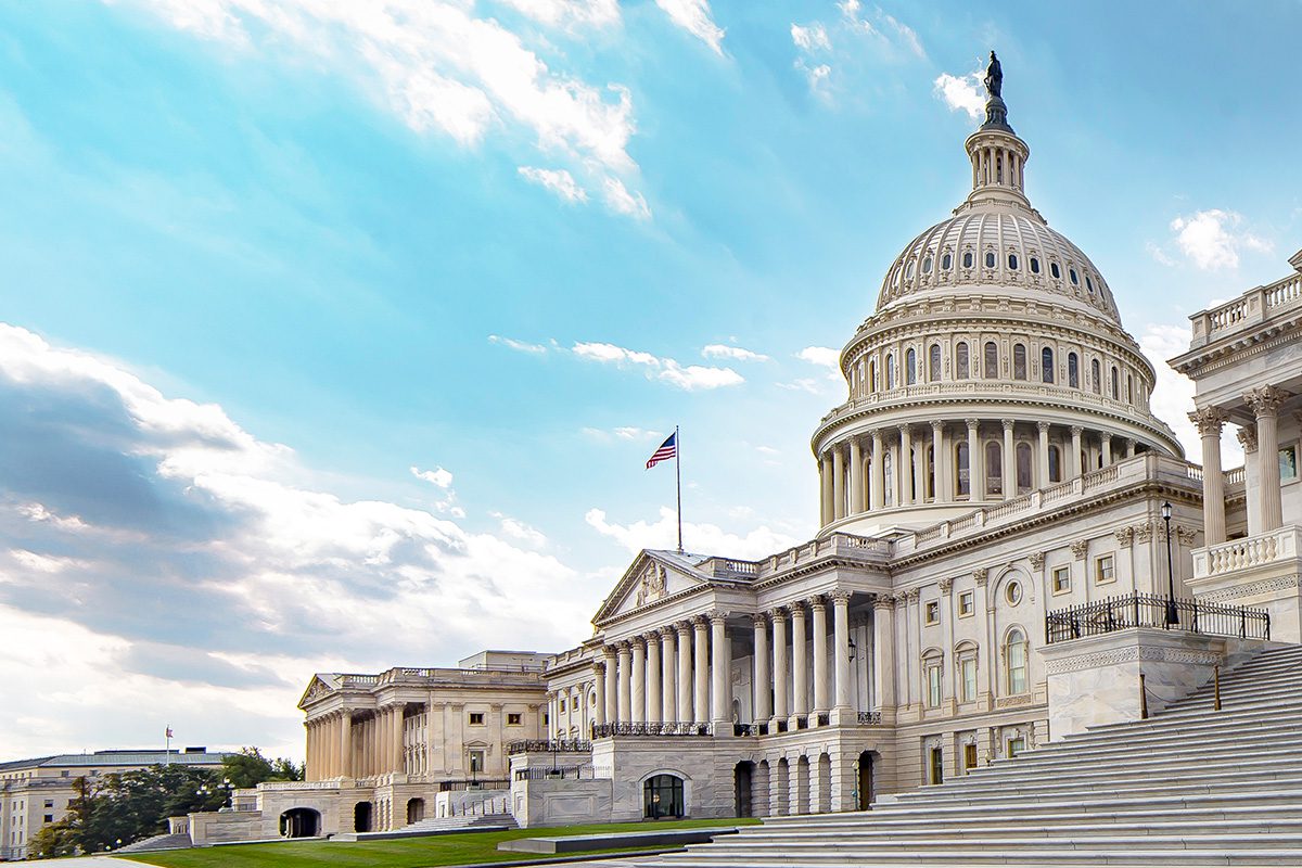 US Capitol building exterior beneath a blue, cloudy sky